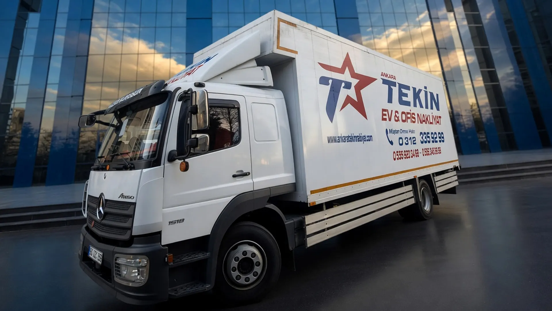 Tekin Nakliyat kamyonu cam cepheli ofis binasının önünde ofis taşıması için yanaşmış